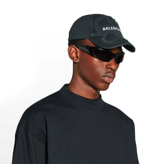 wearing nón BALENCIAGA BB LASER DESTROYED CAP IN BLACK 719282410B21077