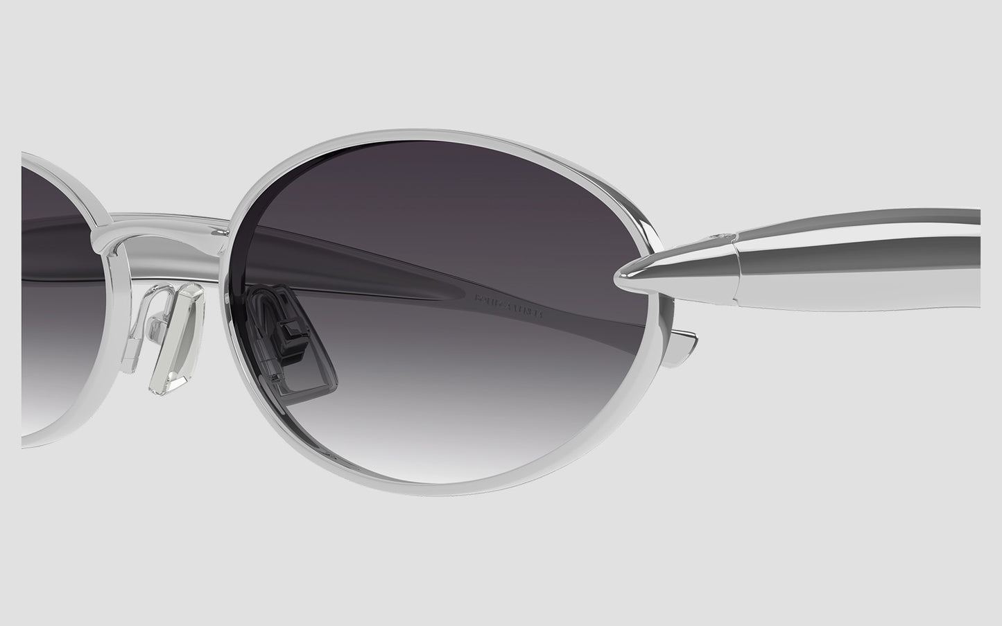 Bottega Veneta Sardine Oval Sunglasses - BV1386S 003 with a gradient lens on a light gray background