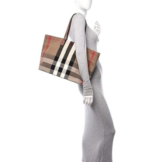 Mannequin wearing a gray dress holding a Burberry Check Canvas Medium London Tote Taupe Brown 8084047 on a white background