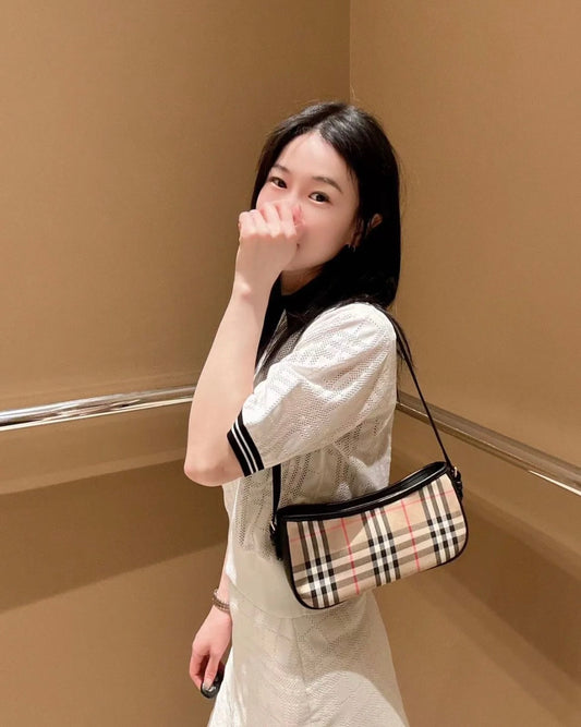 wearing BURBERRY VINTAGE CHECKED CAMEL AND BLACK SLING BAG 80788371