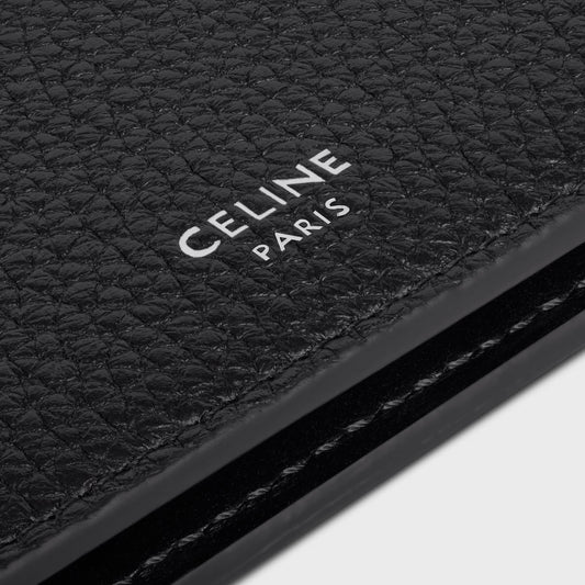 Close-up of a black leather product with 'CELINE PARIS' branding.