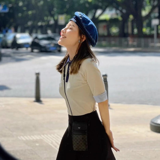 wearing CELINE PHONE POUCH WITH FLAP IN TRIOMPHE CANVAS AND LAMBSKIN BLACK 10G332CQD.38SI