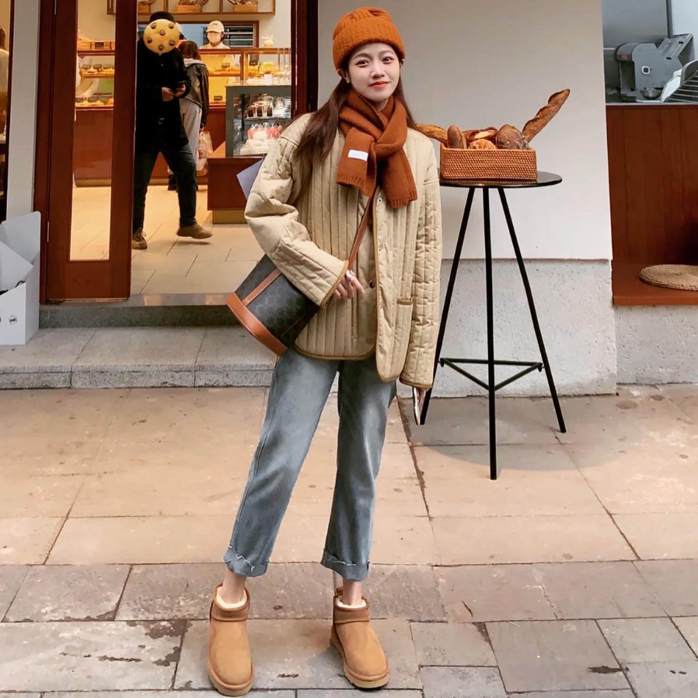 wearing CELINE SMALL BUCKET IN TRIOMPHE CANVAS AND CALFSKIN TAN 191442CAS.04LU