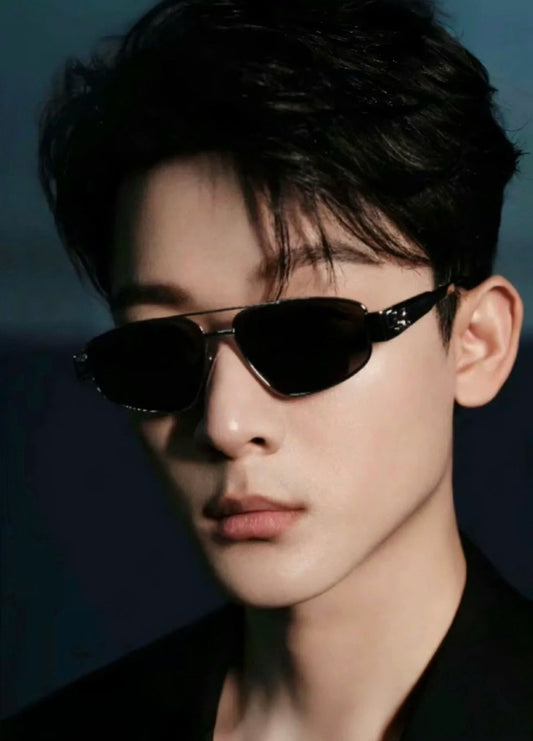 Person wearing Celine Triomphe Metal 03 Sunglasses in Metal – CL40281U 16A with a dark background