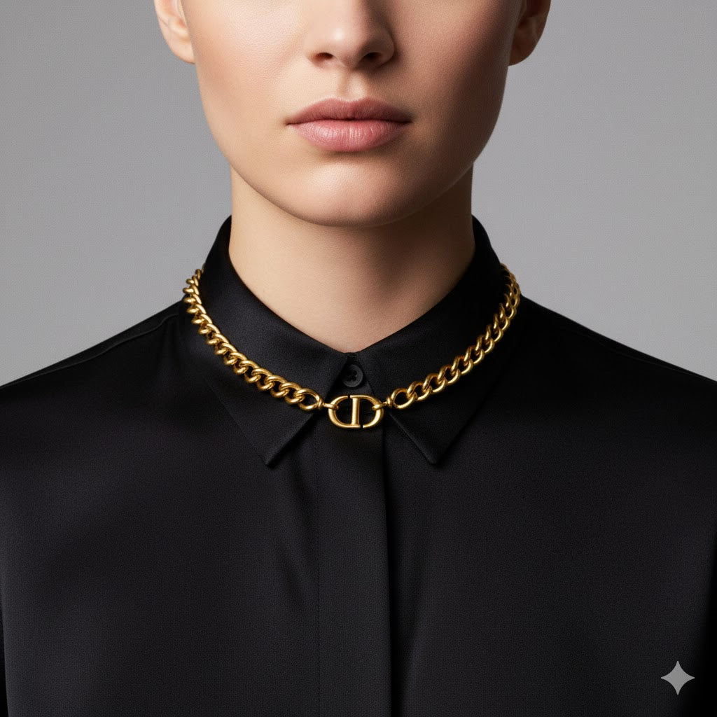 Person wearing a black shirt with Dior CD Navy Choker Necklace on a gray background