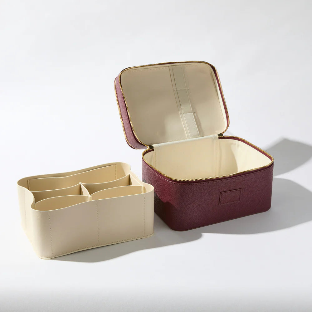 Etoile Duo Vanity Case Ginger Burgundy Two travel organizers, one beige with compartments and one burgundy, on a light gray background.