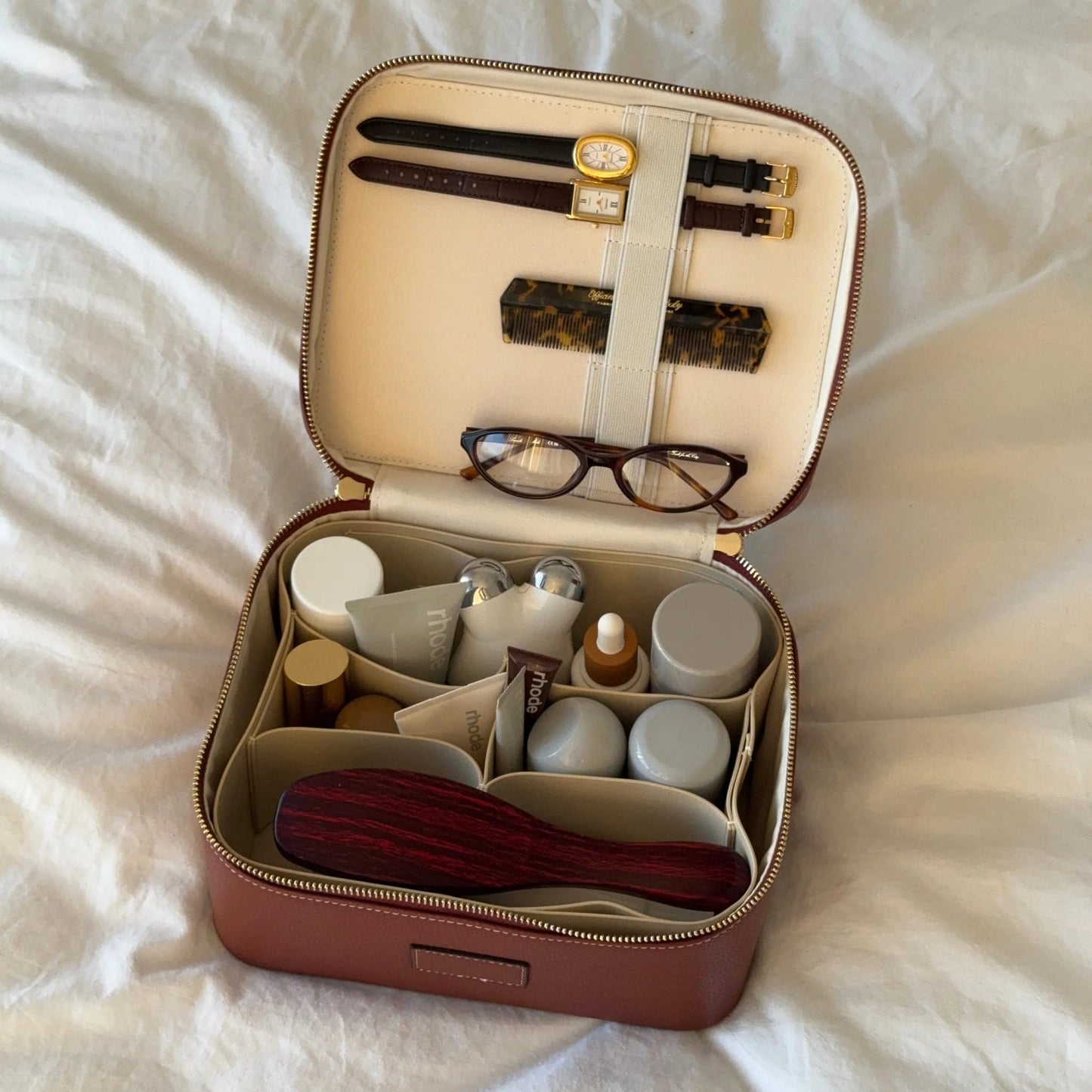 Open Etoile Vanity Case Espresso with toiletries and glasses on a white surface