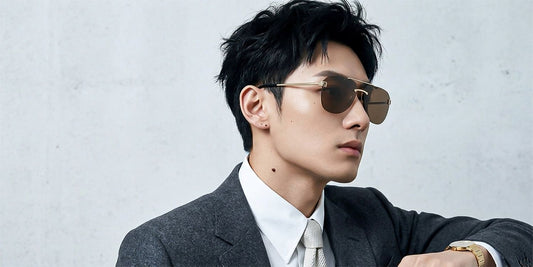 Man wearing Fendi FE40115U-32E Sky Yellow Aviator Sunglasses and a suit against a plain background