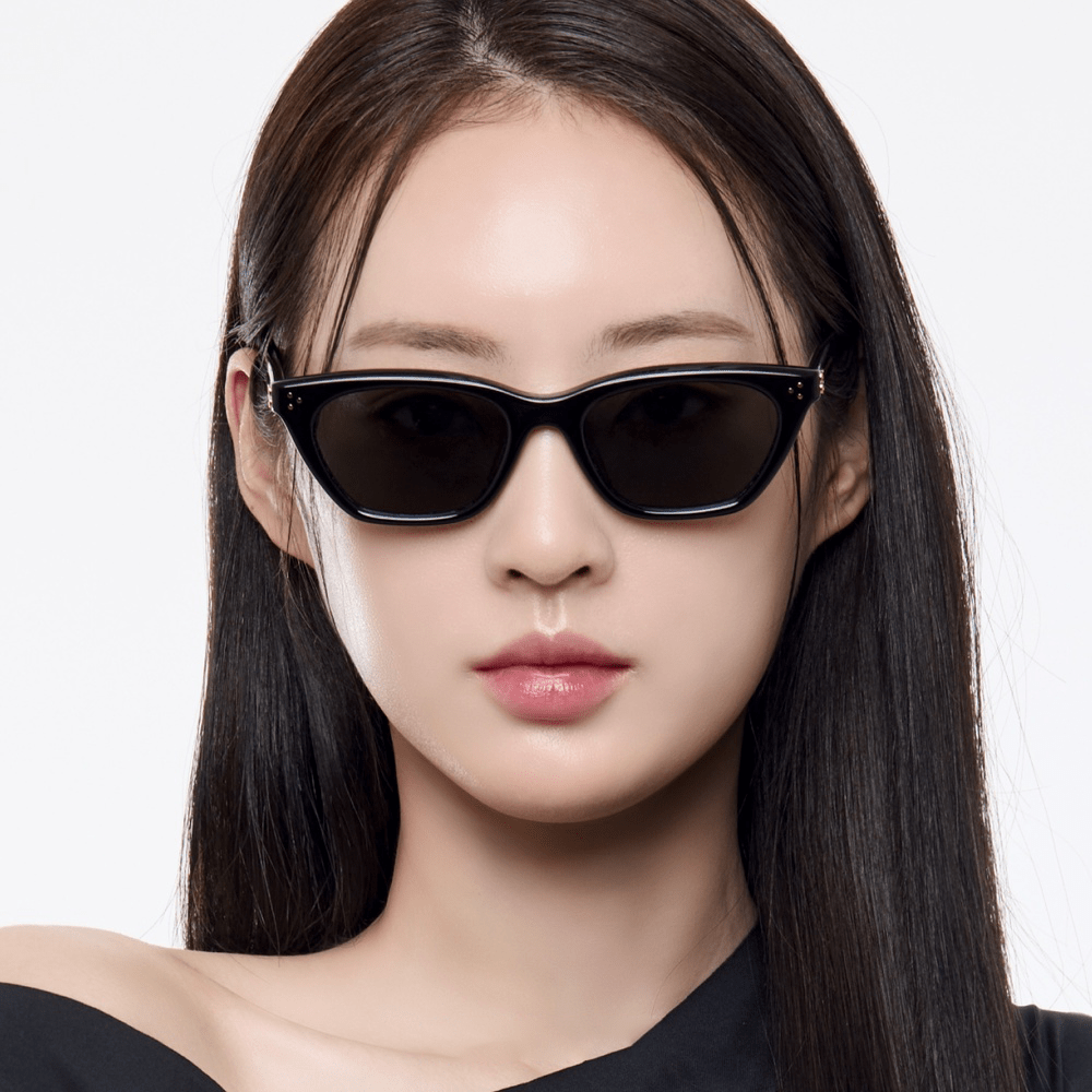 Woman wearing Gentle Monster Gisele 01 with a plain background