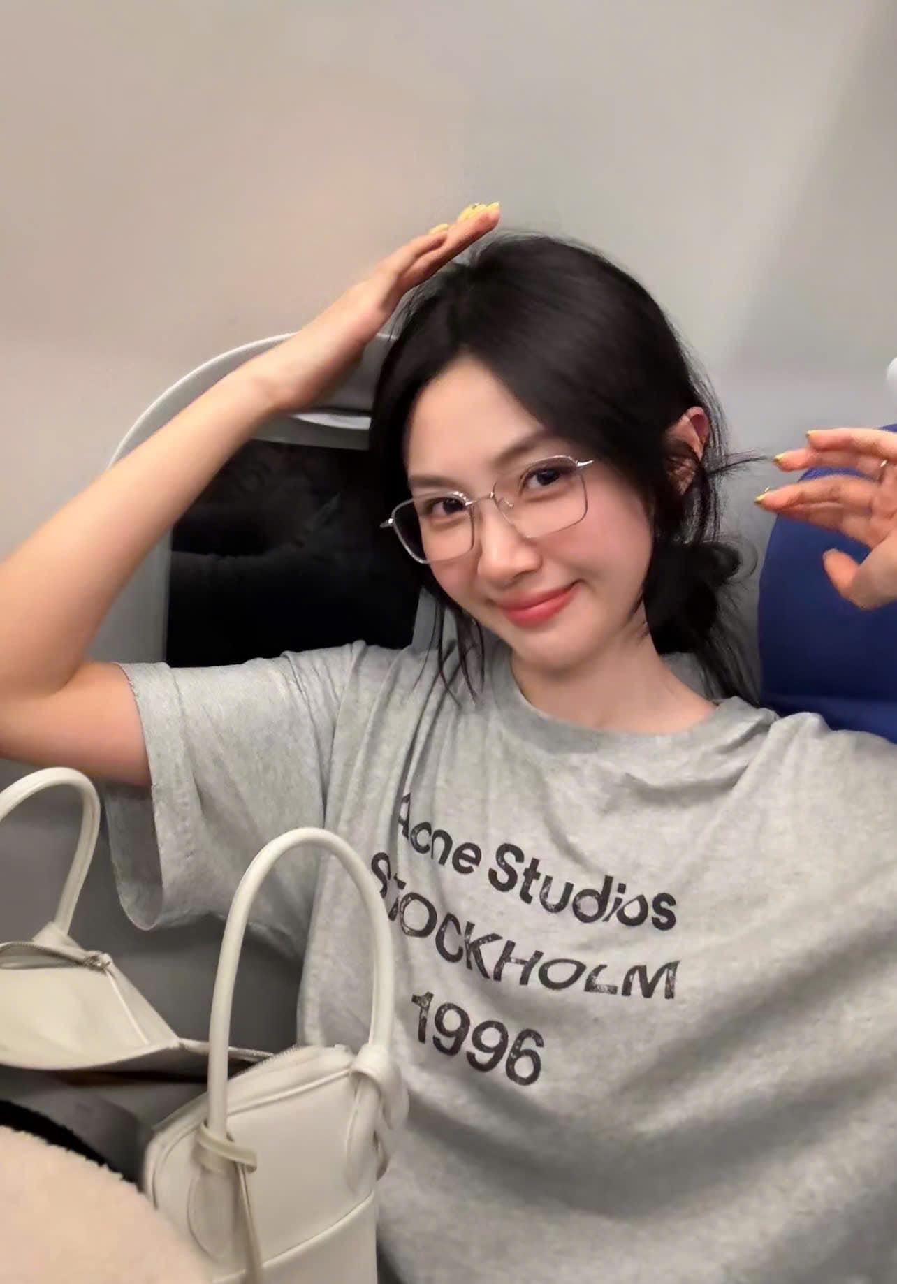 Person wearing a gray 'Acne Studios Stockholm 1996' t-shirt with GENTLE MONSTER (GM) ABA (02)