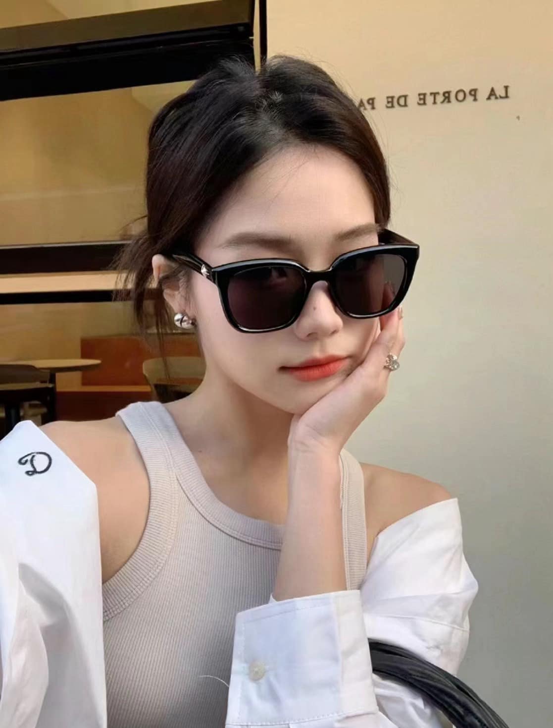 Woman wearing GENTLE MONSTER GM BILLY (01) with a blurred background