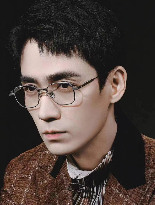 Man wearing Gentle Monster (GM) Catta C2 and a brown jacket with a dark background