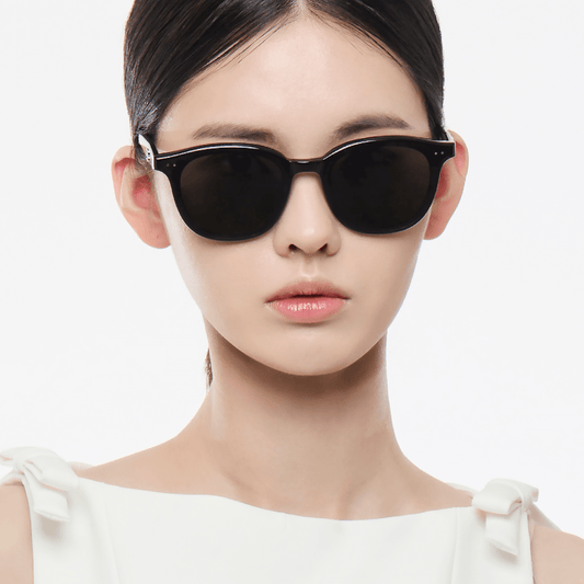 Woman wearing black Gentle Monster (GM) Jude 01 with a plain background