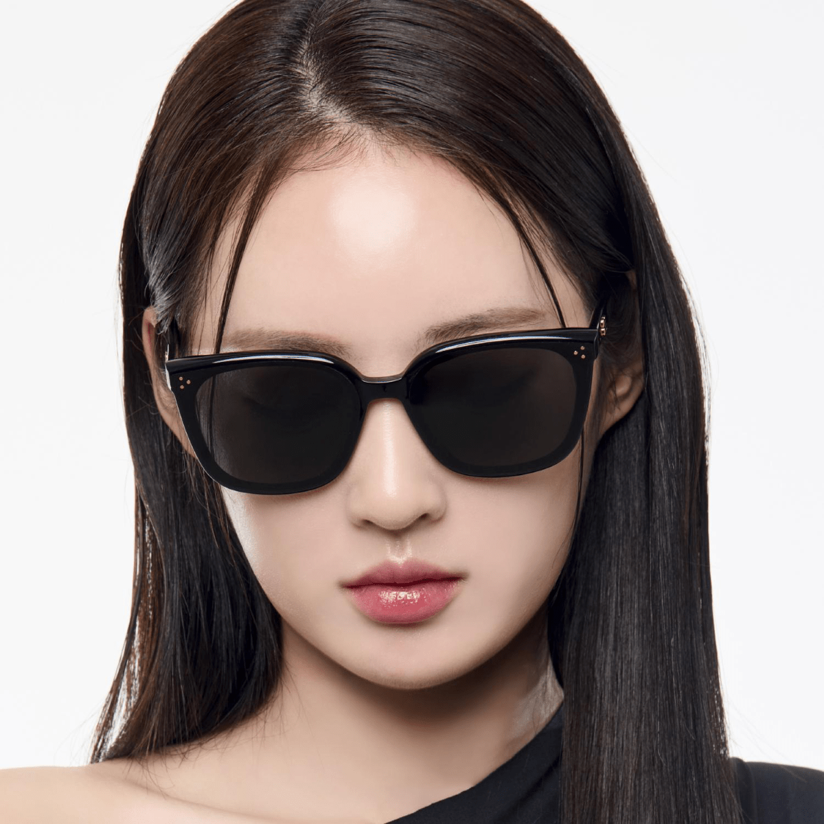 Woman wearing Gentle Monster (GM) Loloe 01 with a plain background