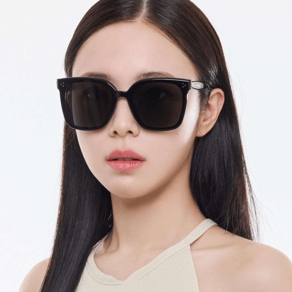 Woman wearing black Gentle Monster (GM) New Her 01 on a white background