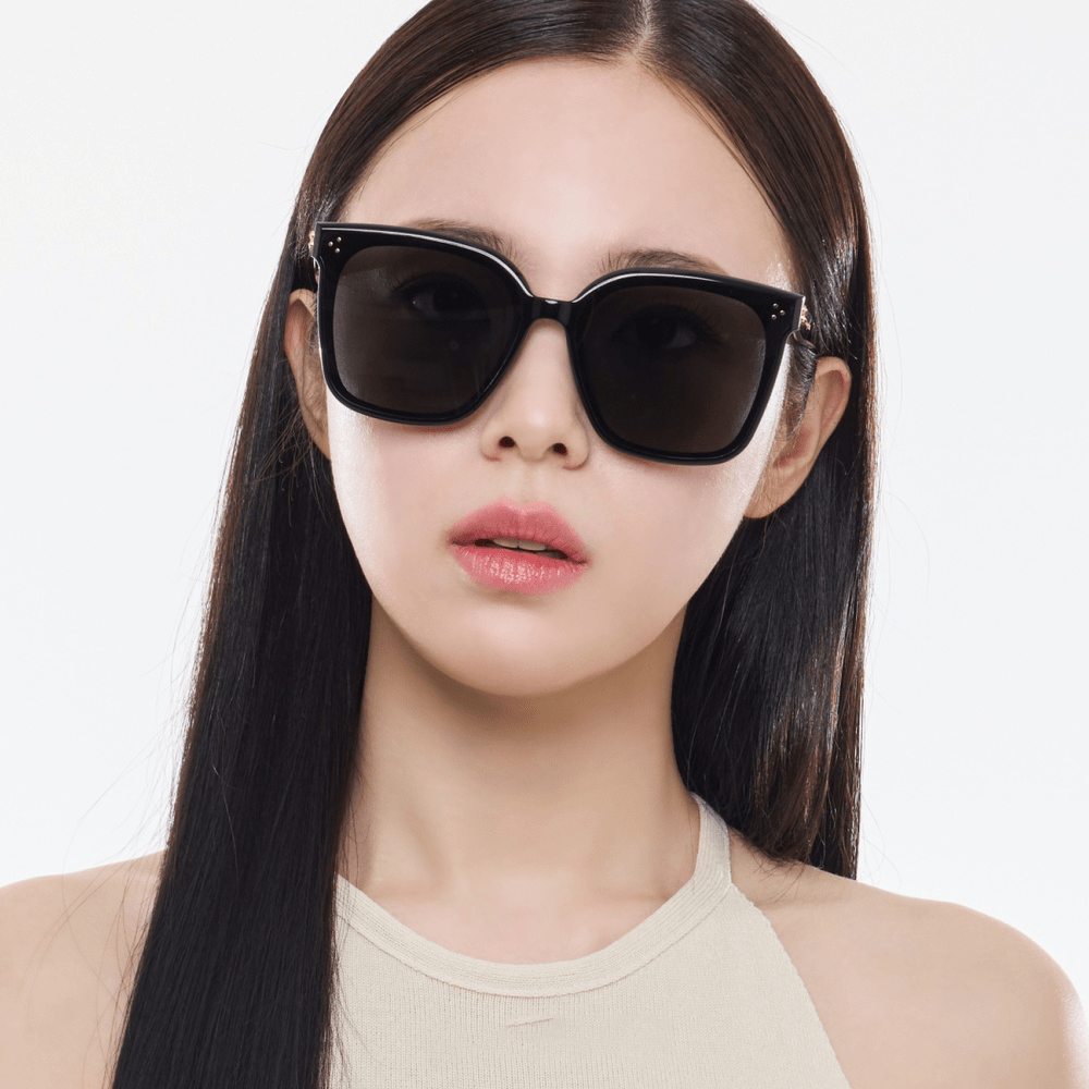 Woman wearing black Gentle Monster (GM) New Her 01 on a white background