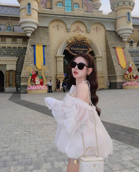 Woman in a white dress wearing Gentle Monster (GM) New Her T1