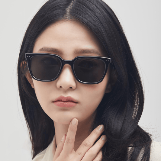 Woman wearing Gentle Monster (GM) Nubo 01 with a grey background