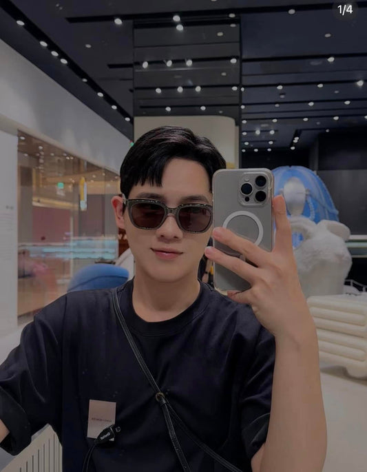 Person wearing Gentle Monster (GM) Nubo G3 taking a selfie in a modern indoor setting