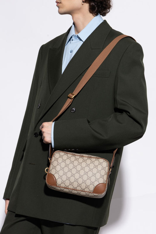 Person wearing a dark green coat with a Gucci GG Embossed Super Mini Cognac Beige Shoulder Bag 821216 FAED3 9786 on a white background
