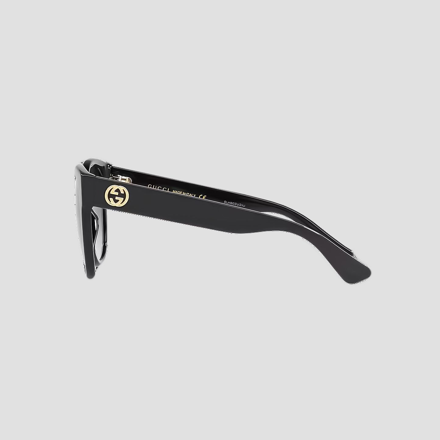 Gucci GG0035SN-001 Round Sunglasses with a gold logo on a light gray background
