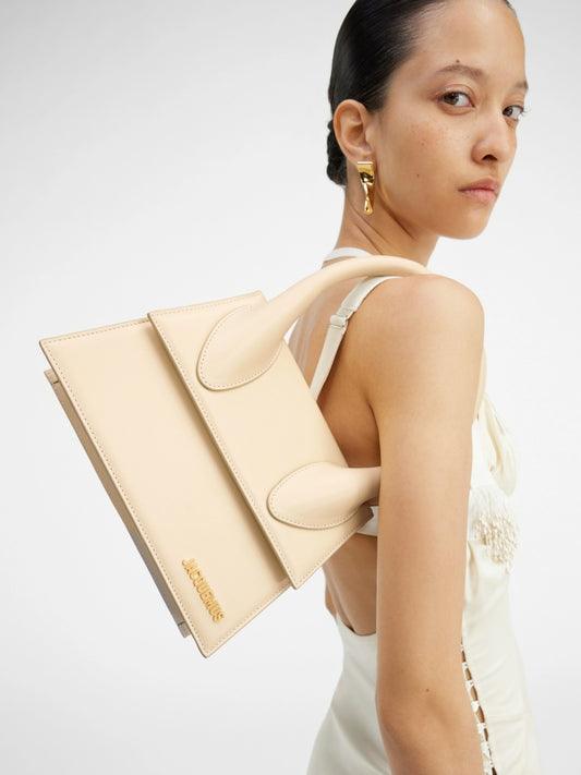 wearing JACQUEMUS LE GRAND CHIQUITO IVORY 213BA003-3060-120