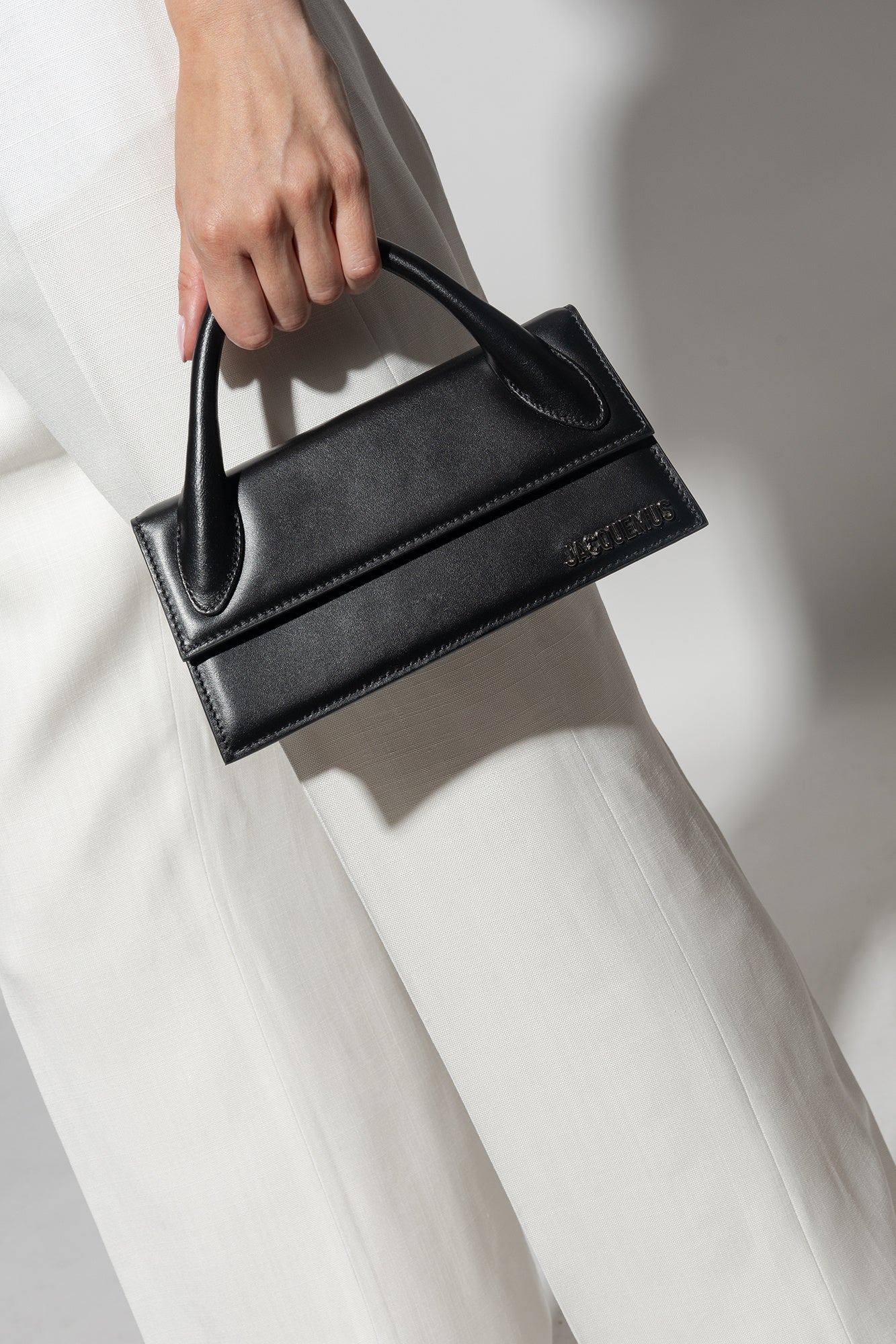 wearing JACQUEMUS LONG CHIQUITO BLACK/SILVER 213BA004-3000-099S