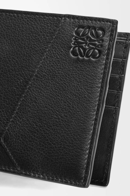 Loewe Puzzle Bifold Wallet in Black Classic Calfskin C510302X16-1100 with brand logo on a white background