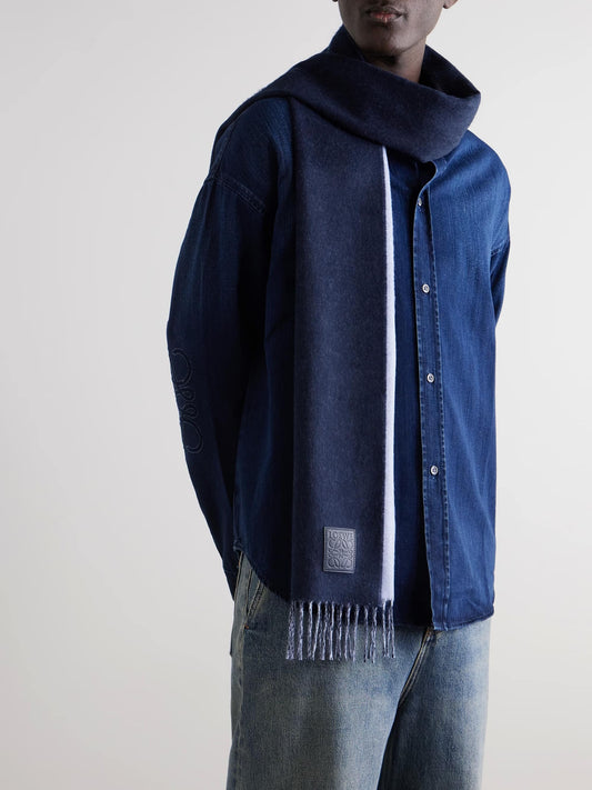 Person wearing a blue jacket with a Loewe Scarf in Wool and Cashmere Navy/Light Blue F811251X06-5142 on a plain background