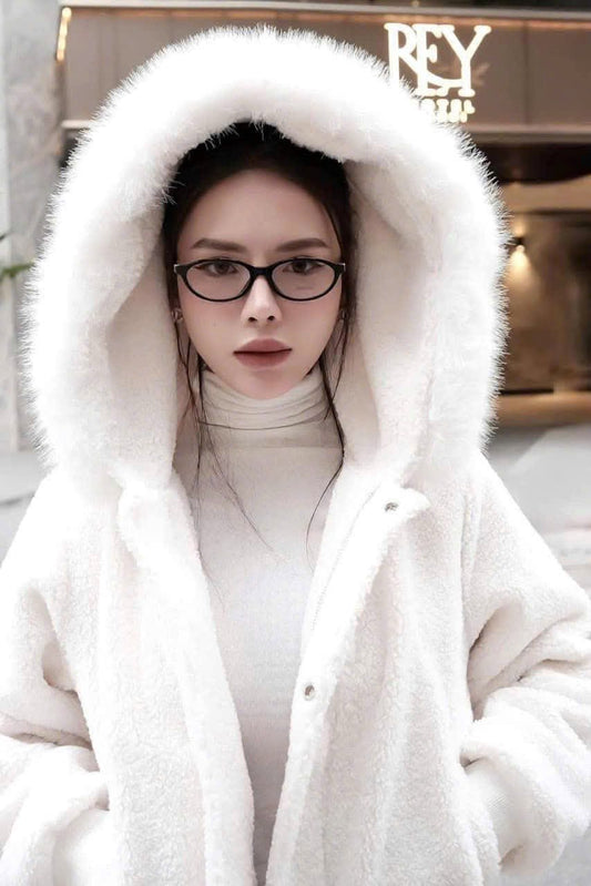 Women wearing a Miu Miu MU 09XV 16K1O1 Eyeglasses and a white fur-lined coat with a hood indoors.