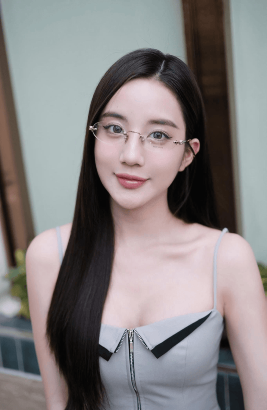 Woman wearing Miu Miu MU 53WV 1BC1O1 Eyeglasses and a gray dress with a blurred background