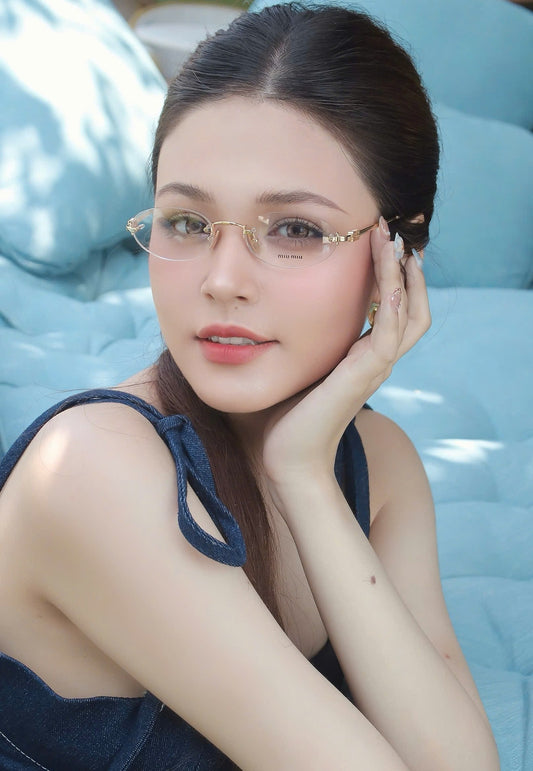 Woman wearing Miu Miu MU 53WV 5AK1O1 Eyeglasses with a blue cushioned background
