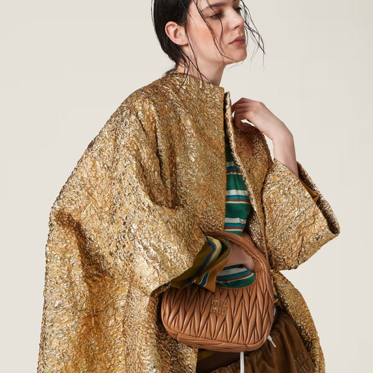 wearing MIU MIU WANDER MATELASSÉ NAPPA LEATHER HOBO BAG IN CARAMEL 5BC125 N88 F098L