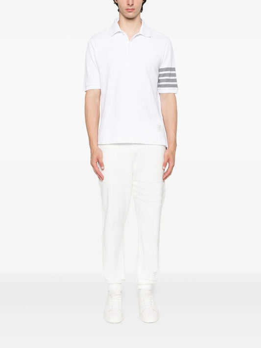 Person wearing a Thom Browne W/ 4-Bar in Sustainable Piqué White MJP136G 07976 100 on a white background