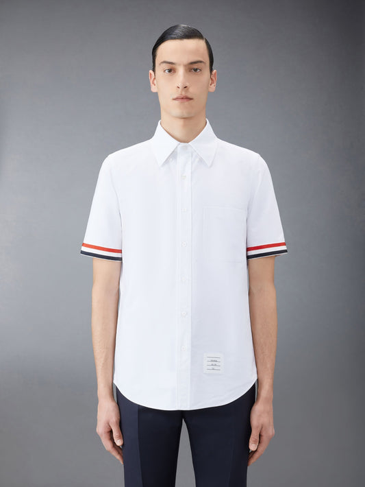 wearing Thom Browne White Straight Fit Oxford Short Sleeve Shirt with RWB Grosgrain Cuffs MWS245A-F0313-100