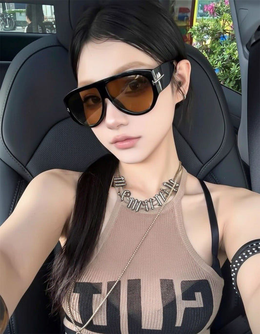 Woman wearing Tom Ford FT1044 01E Bronson Sunglasses and a tank top inside a car