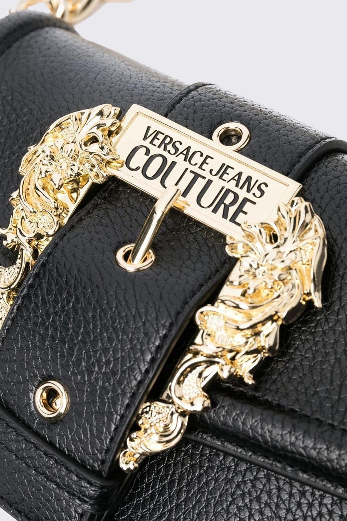 Black Versace handbag with gold decorative clasp on a light gray background