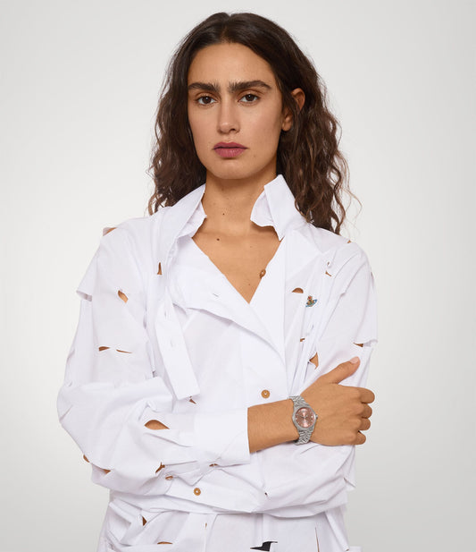 Woman wearing a white outfit with Vivienne Westwood Little Seymour Pink Dial Silver Watch VV328DPKSL 8050164231842 on a plain background