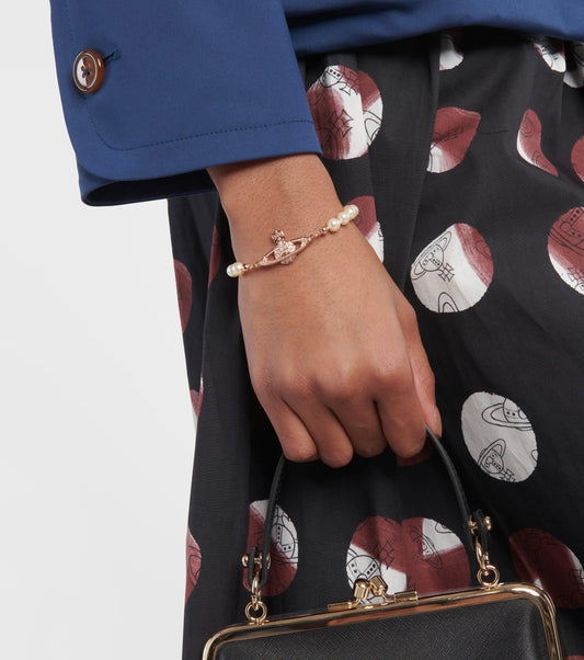 wearing Vivienne Westwood Rose Gold Mini Bas Relief Pearl Bracelet 61030001-02G121-CN