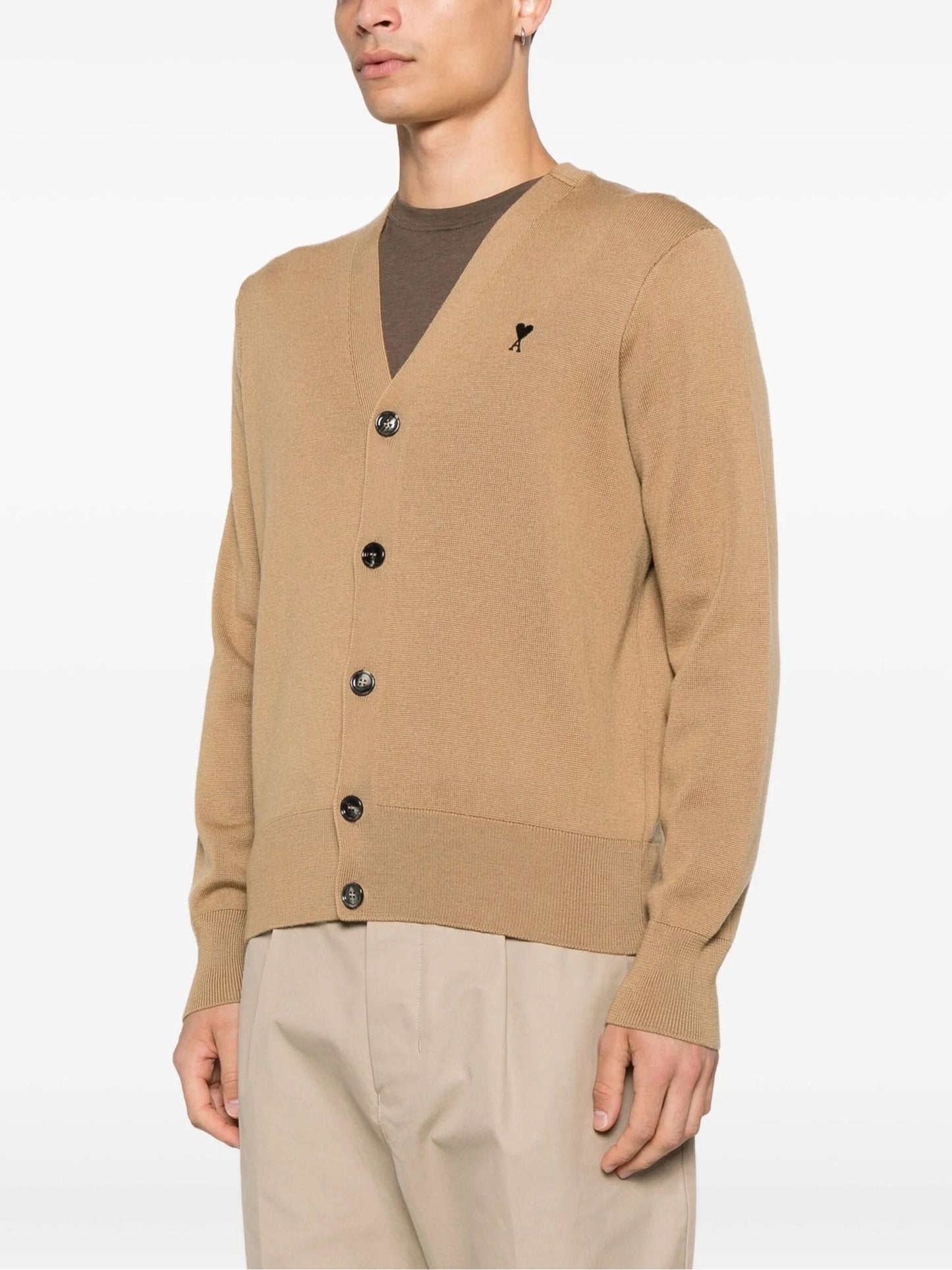 Man wearing a Wool Ami De Coeur Cardigan Camel/Black HKC361.001.288 over a brown shirt on a white background
