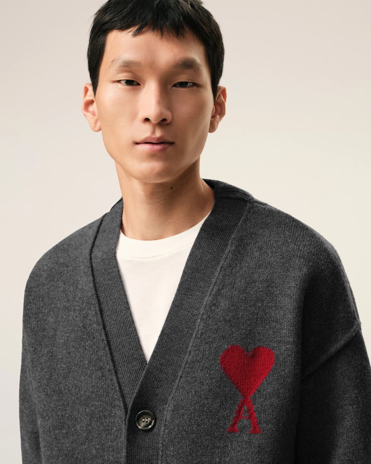 Man wearing a Grey Wool Ami De Coeur Cardigan Heather Grey/Red UKC367.018.084 on a plain background