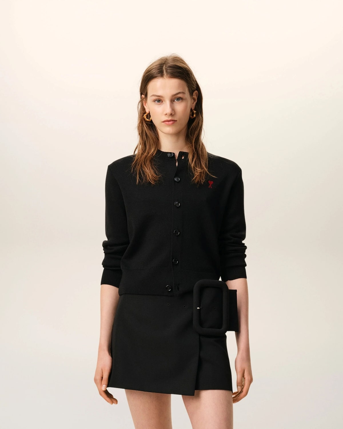 Woman wearing a Black Wool Ami De Coeur Women Cardigan FKC361.001.009 with a belt on a white background