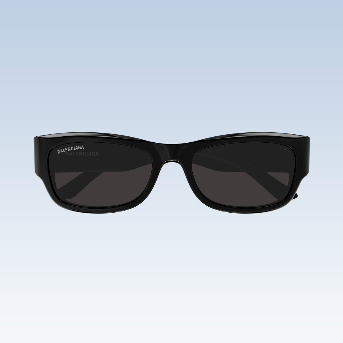 Balenciaga BB0390SK 001 Black Square Sunglasses with a glossy black frame and dark gray lenses, shown from the front against a light blue gradient background.