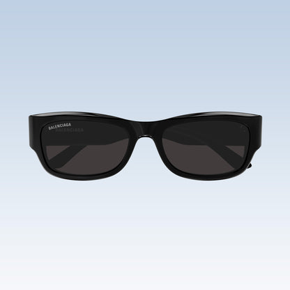 Balenciaga BB0390SK 001 Black Square Sunglasses with a glossy black frame and dark gray lenses, shown from the front against a light blue gradient background.