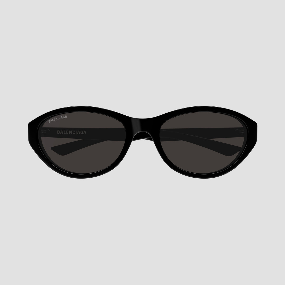 Balenciaga BB0404SK 001 Black Oval Sunglasses and white branding text on the eyepiece, shown against a plain white background.