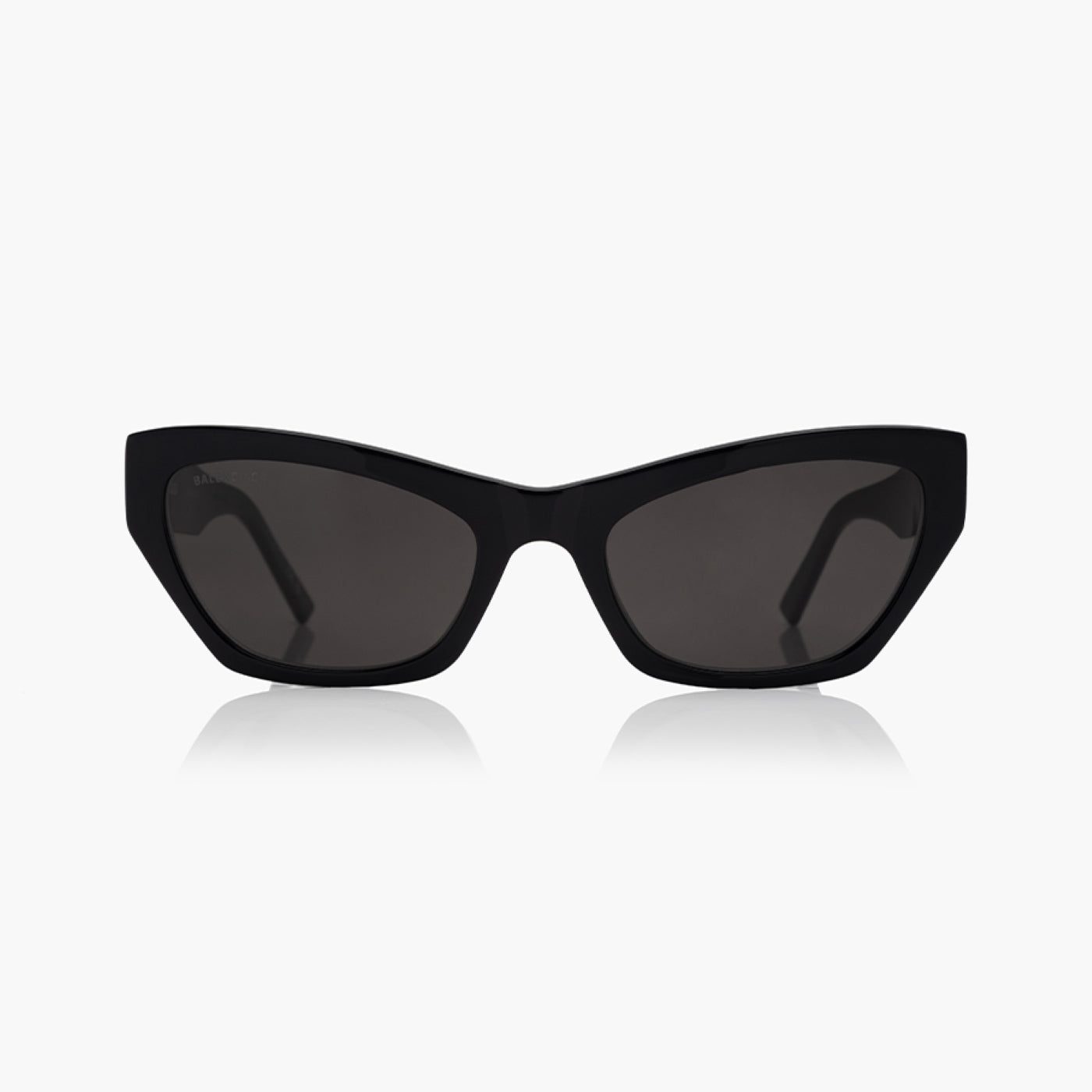 Balenciaga BB0447S Black Cat-Eye Sunglasses with dark tinted lenses, shown from the front on a light gray background with a soft reflection below.