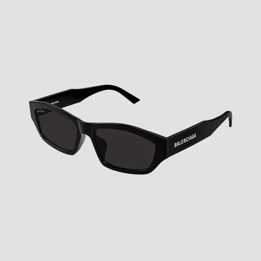 Balenciaga BB0448SK 001 Black Rectangular Sunglasses with dark lenses and white brand lettering on the temple, shown on a light gray background.