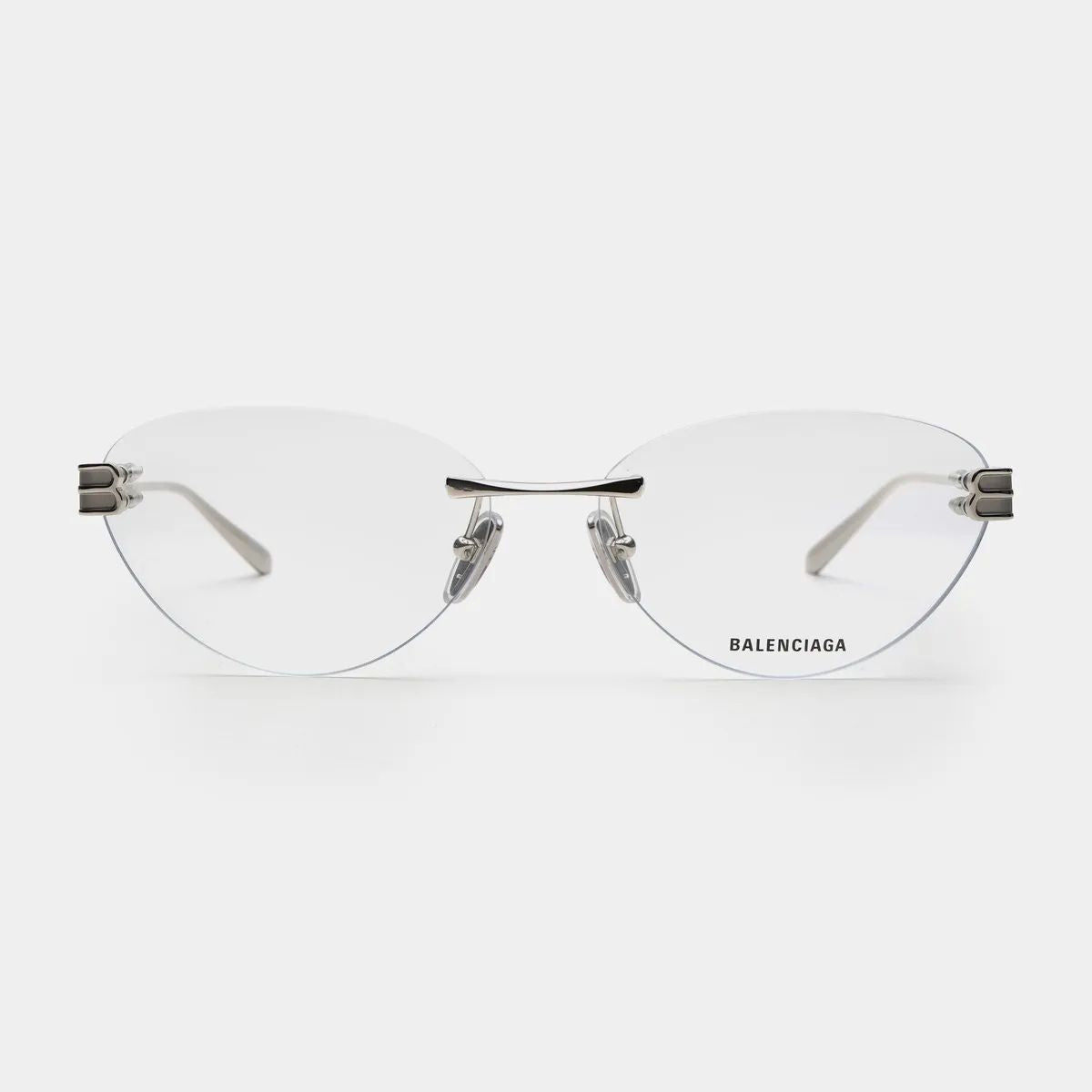 Balenciaga BB0489O-001 Silver Rimless Butterfly Eyeglasses with clear acetate lenses and silver metal hinges, shown from the front on a light gray background.