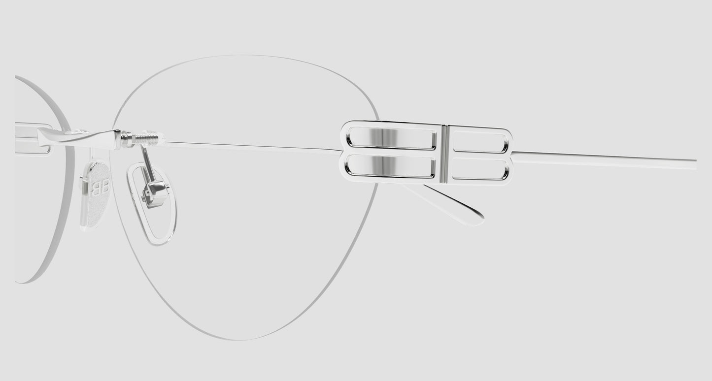 A close-up studio shot of a pair of Balenciaga BB0489O-001 Silver Rimless Butterfly Eyeglasses with a minimalist silver metal bridge and temple arm, shown against a solid light gray background.