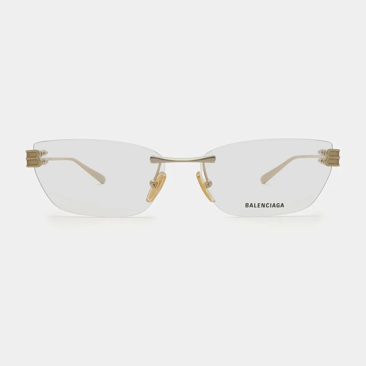 Balenciaga BB0490O-004 Gold Rimless Cat-Eye Eyeglasses with gold metal hardware and clear lenses, shown against a light gray background.